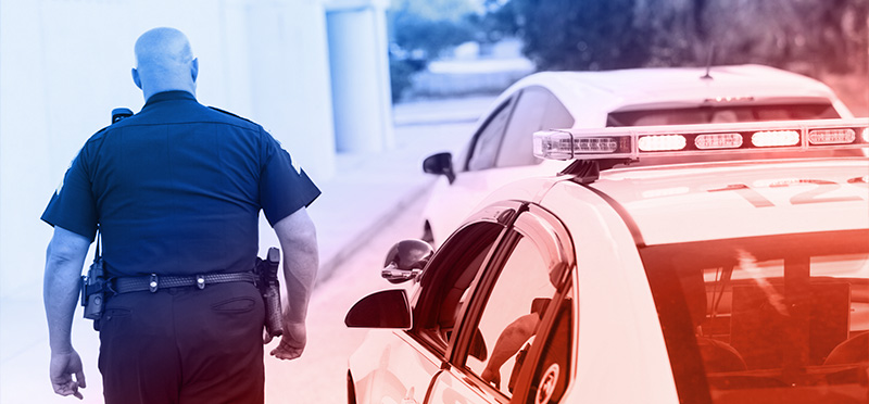 Police officer walking towards car